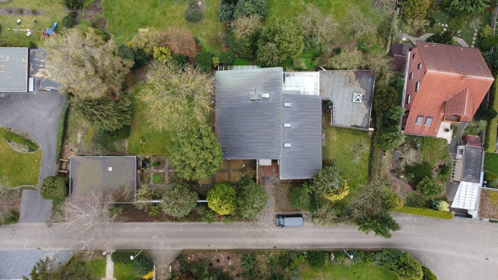 Aerial view of suburban house rooftops and gardens